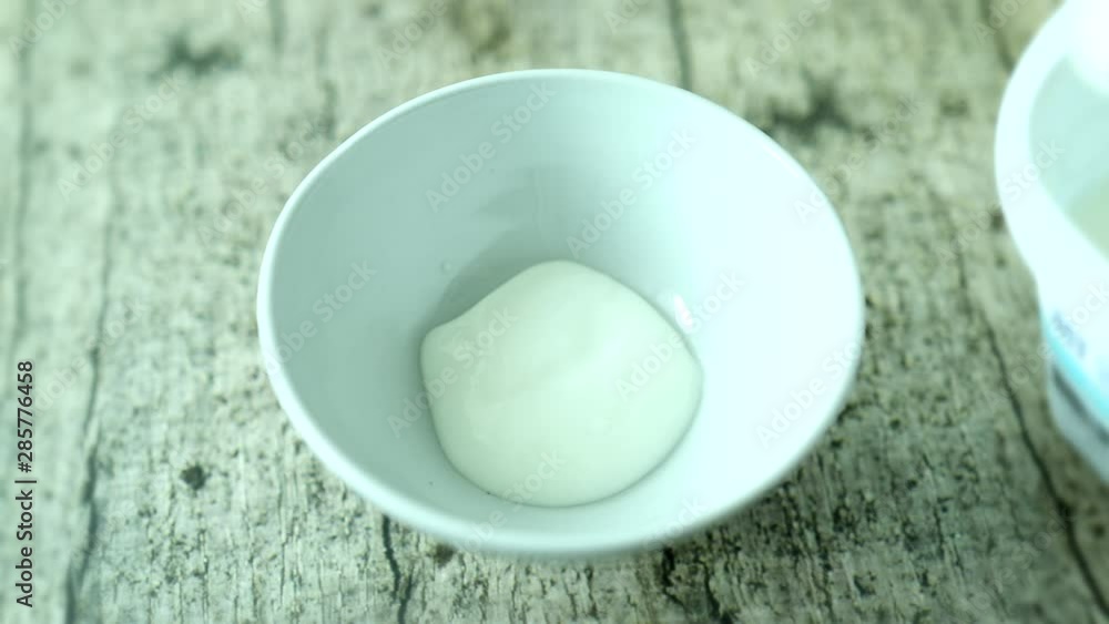 Putting plain yogurt and fig red wine compote into ceramic bowl Putting plain yogurt and fig red wine compote into ceramic bowl