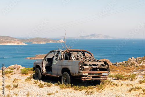 Fototapeta Naklejka Na Ścianę i Meble -  Wrecked vintage car in the island of Patmos, greece