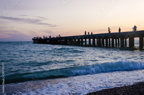 Silhouettes of people and sea