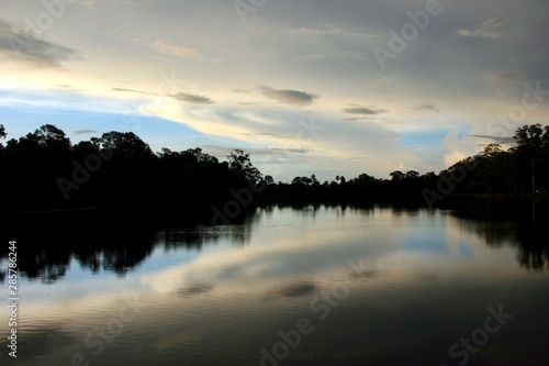 sunrise with tree and clouds reflection on the lake, Angkor, Cambodia