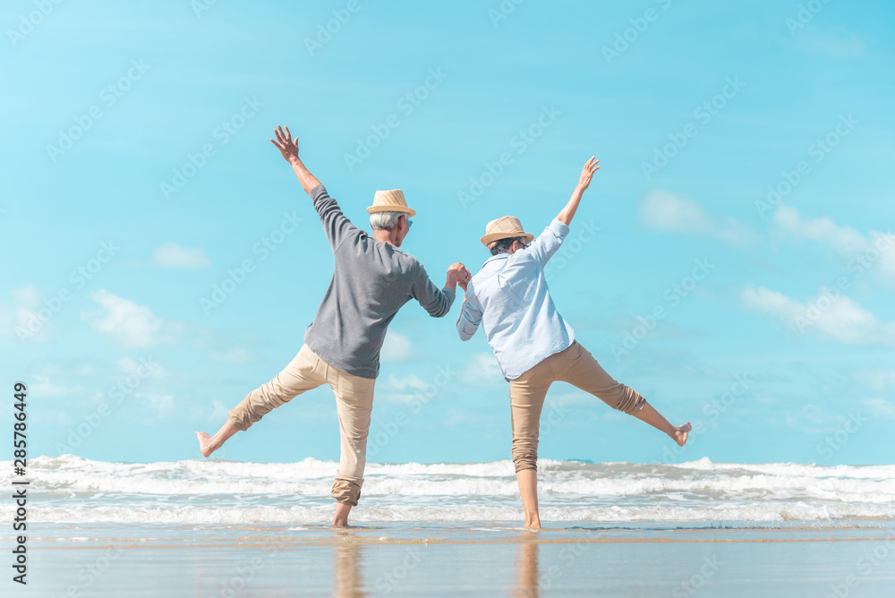Charming elderly couple went to the beach to enjoy the sea breeze Charming elderly couple went to the beach to enjoy the sea breeze