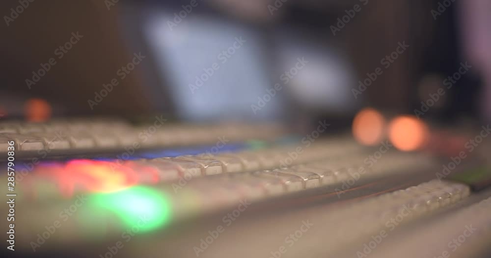 TV engineer at editor in studio. TV editor working with vision mixer in a television broadcast gallery.Man sat at a vision mixing panel in a television studio gallery. video mixer use. TV engineer at editor in studio. TV editor working with vision mixer in a television broadcast gallery.Man sat at a vision mixing panel in a television studio gallery. video mixer use.