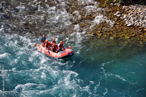 Alanya / Turkey - August 18, 2019: Rafting, a group of young people with a guide rafting along a mountain river. Extreme and fun sport at a tourist attraction.