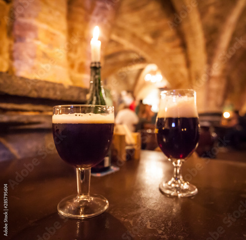 Two glasses of craft beer in a typical belgian pub.