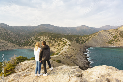 A guy and a girl watching from the Cape Kapchik on the mountain Koba-Kaya (Cave or eagle) and Karaul-Oba. Left and right - Blue (robber) and Blue (Dailymanna, Royal) Bay © garmashevanatali