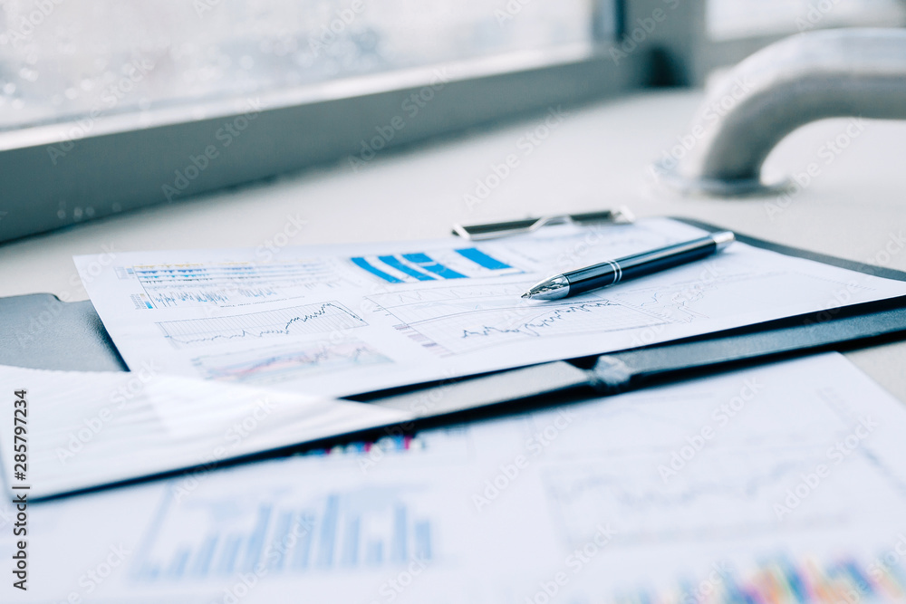 pen and financial documents on the desktop in the office pen and financial documents on the desktop in the office