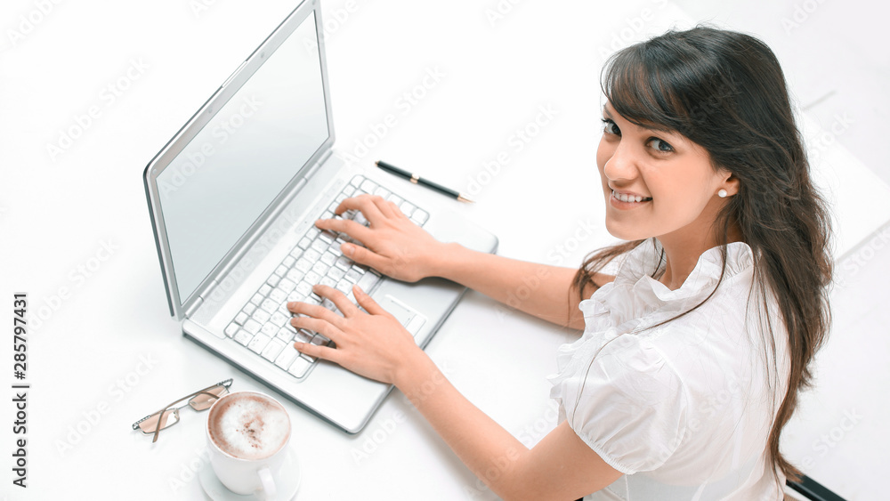 closeup.young woman working on laptop. the view from the top closeup.young woman working on laptop. the view from the top