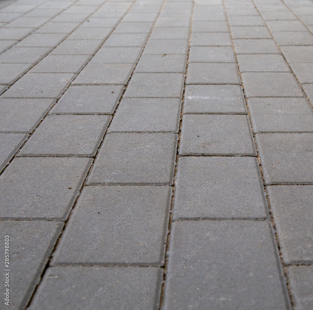 Gray rectangular paving slabs. Texture.