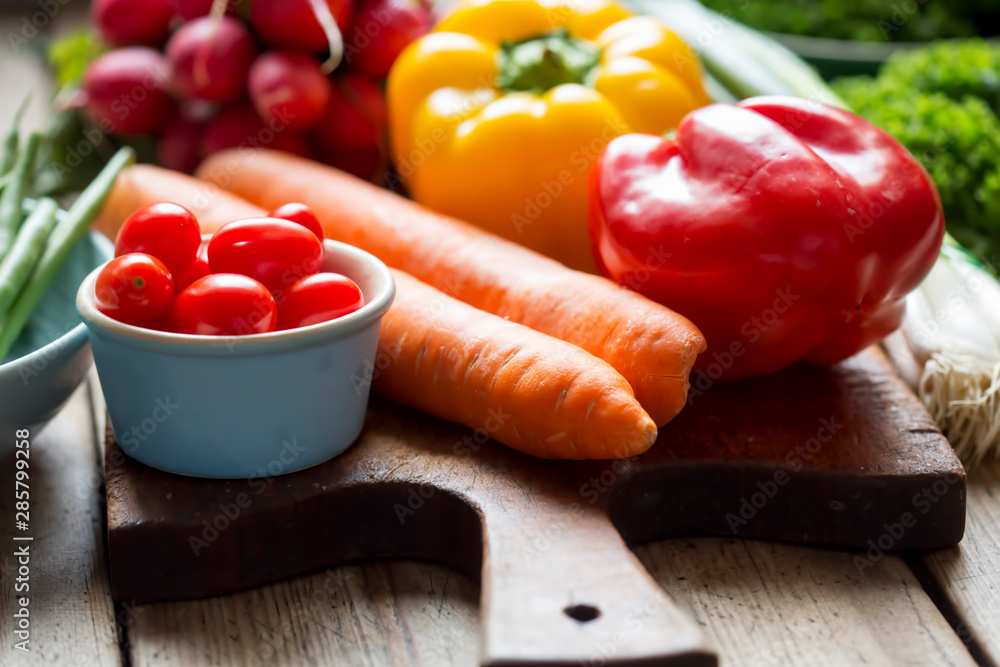 Red & yellow pepper, green scallions, tomatoes, green beans, red onion, kale. Vegetables on wooden board. Red & yellow pepper, green scallions, tomatoes, green beans, red onion, kale. Vegetables on wooden board.