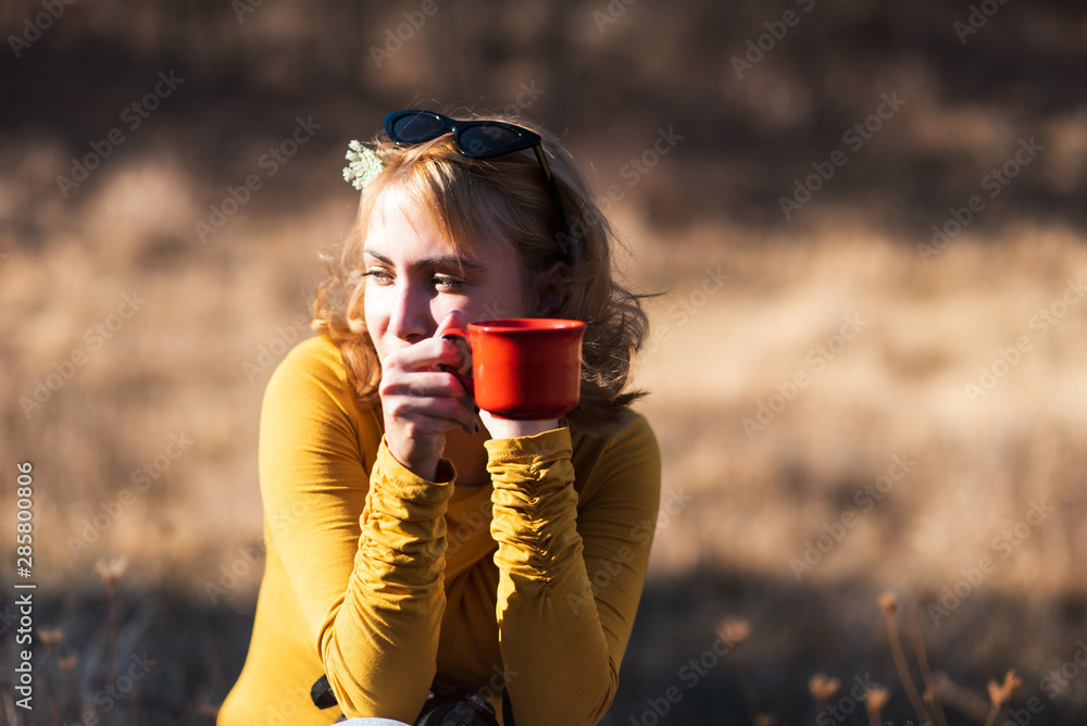 Woman having a cup of coffee outdoors Woman having a cup of coffee outdoors