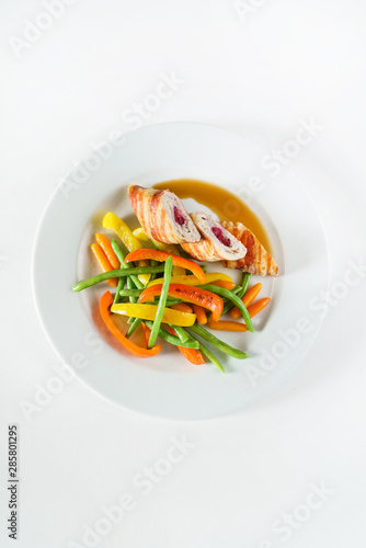 stuffed chicken with vegetables on white