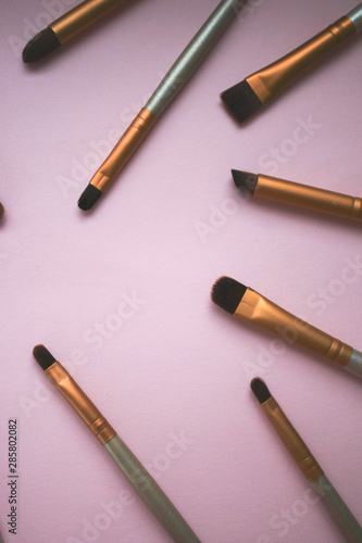 Makeup brushes on pink background