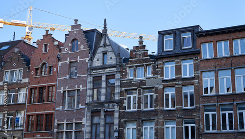 Old architecture houses in Belgium with crane in background