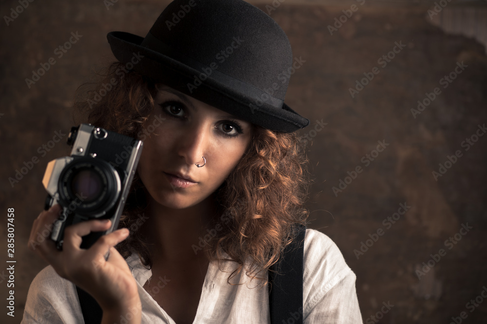 Woman Photographer with Bowler and Suspenders Holding a Camera Woman Photographer with Bowler and Suspenders Holding a Camera