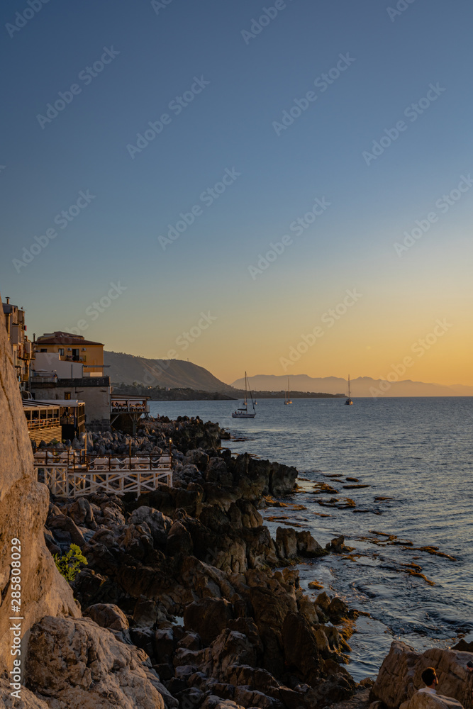 A sunset view from the rocky coast of Cefalu