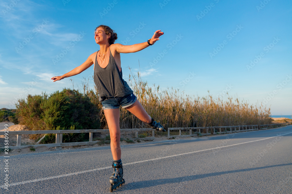 young woman skates happy outdoors young woman skates happy outdoors
