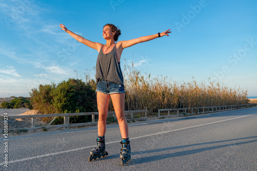 young woman skates happy outdoors
