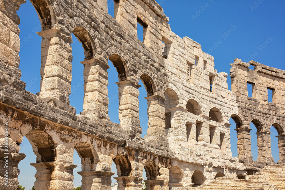 Ancient wall of amfitheater in Pula, Croatia. Historic heritage tourism and travel background