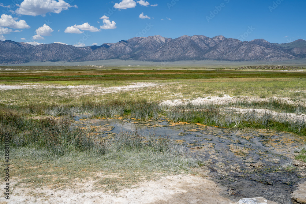 Hot springs (Wild Willys) in Mammoth Lakes California, with the Eastern Sierra Nevada mountains in background