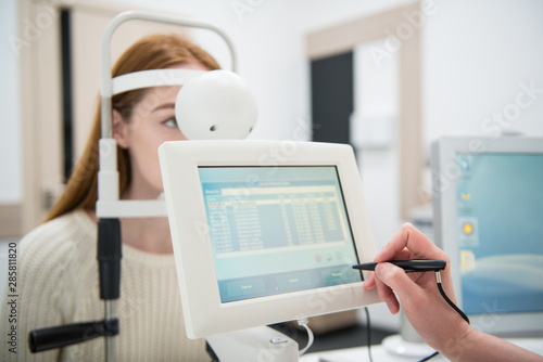 young girl patient on reception at doctor ophthalmologist. diagnostic ophthalmologic equipment. medicine concept