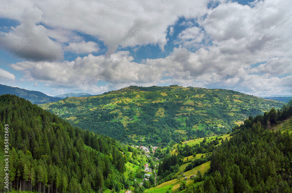 Naklejka premium High mountain panorama drone fly above the mountains In summer. Aerial View Above in the Carpathian Mountains And Meadows.