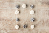 Christmas frame made of festive decorations and pine cones on wooden table. Christmas background. Flat lay. Top view, copy space