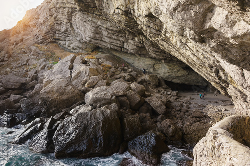 Tourists visiting the Grotto Golitsyn  Pop  Chaliapin grotto      a large natural grotto  knocked out by sea waves in the mountain Koba-Kaya  Cave  near the village of Novy Svet in the Crimea