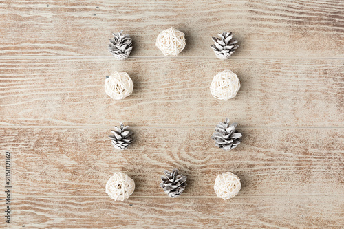 Christmas frame made of festive decorations and pine cones on wooden table. Christmas background. Flat lay. Top view, copy space