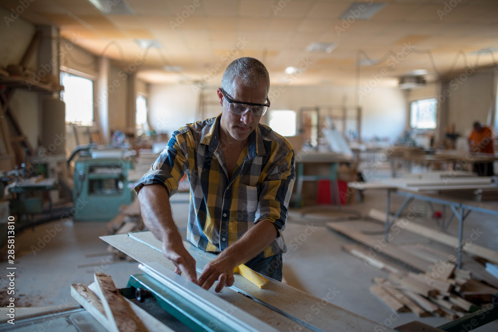 a carpenter processes a massive piece of wood a carpenter processes a massive piece of wood
