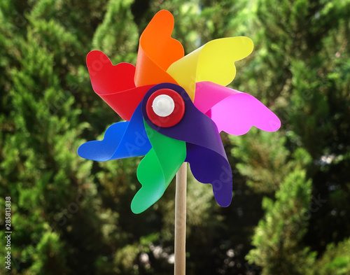 colorful pinwheel on green garden background
