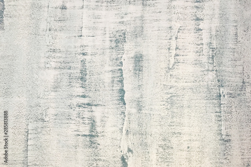 Abstract weathered texture stained old stucco light gray and aged paint white brick wall background in rural room.