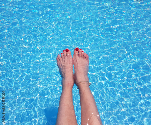 female feet in swimming pool