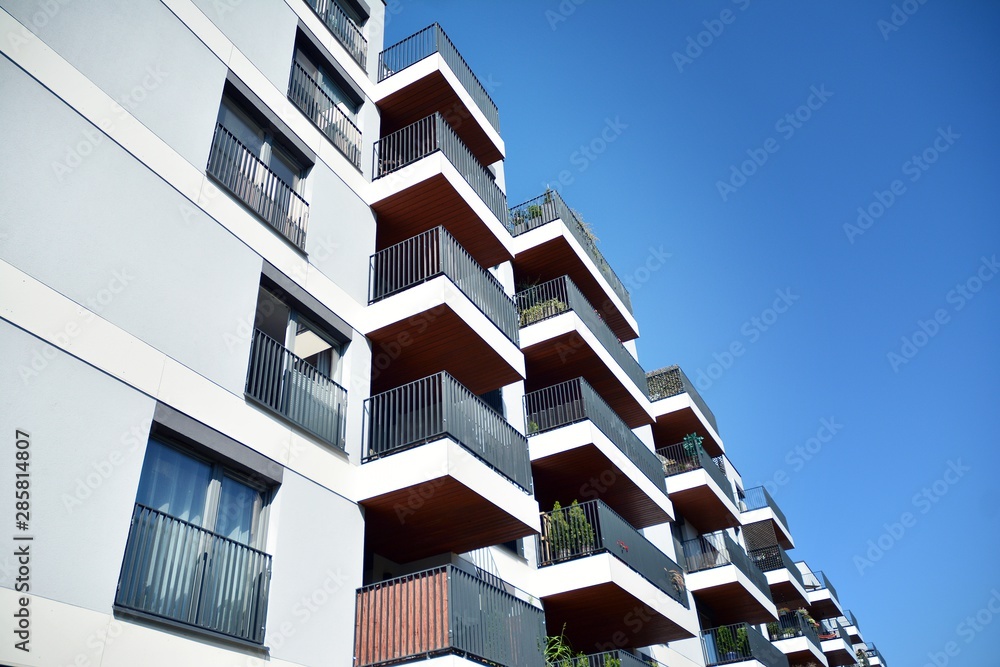 Modern apartment buildings on a sunny day with a blue sky. Facade of a modern apartment building Modern apartment buildings on a sunny day with a blue sky. Facade of a modern apartment building
