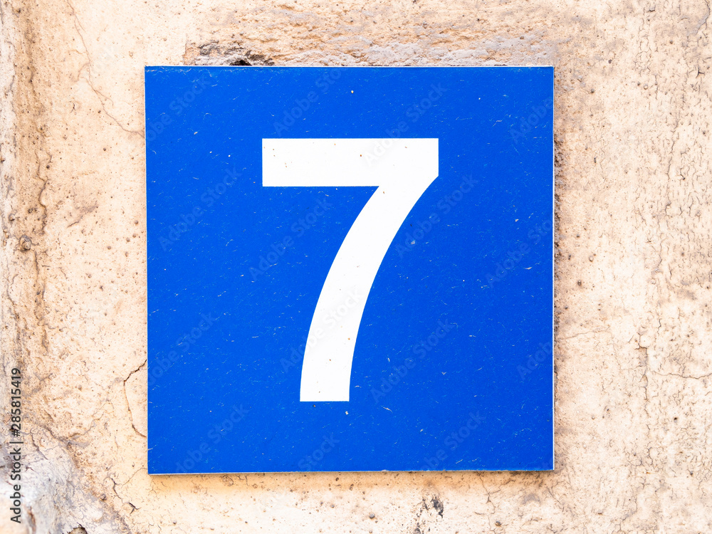 Number 7, seven, street number sign on the wall Number 7, seven, street number sign on the wall