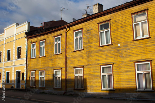 Old wooden shabby yellow building in historical center of Parnu