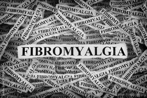 Torn pieces of paper with the word Fibromyalgia photo