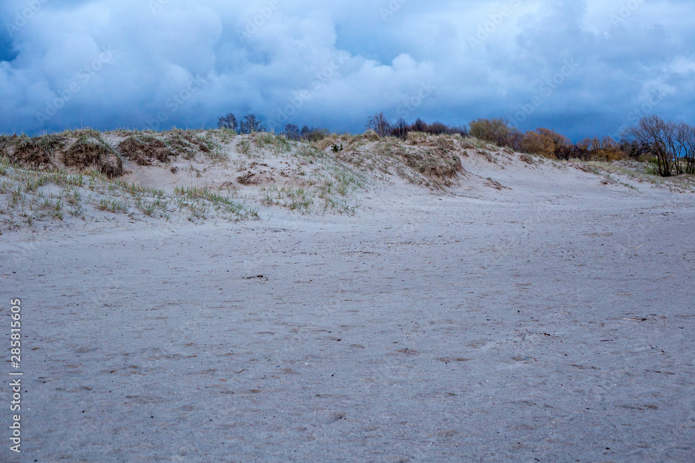 View of the sandy shore of the Parnu bay in evening. It a bay in the northeastern part of the Gulf of Livonia (Gulf of Riga of Baltic Sea), in southern Estonia. View of the sandy shore of the Parnu bay in evening. It a bay in the northeastern part of the Gulf of Livonia (Gulf of Riga of Baltic Sea), in southern Estonia.