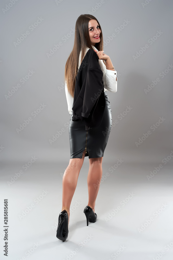 Full length studio shot of a latino businesswoman on gray background Full length studio shot of a latino businesswoman on gray background