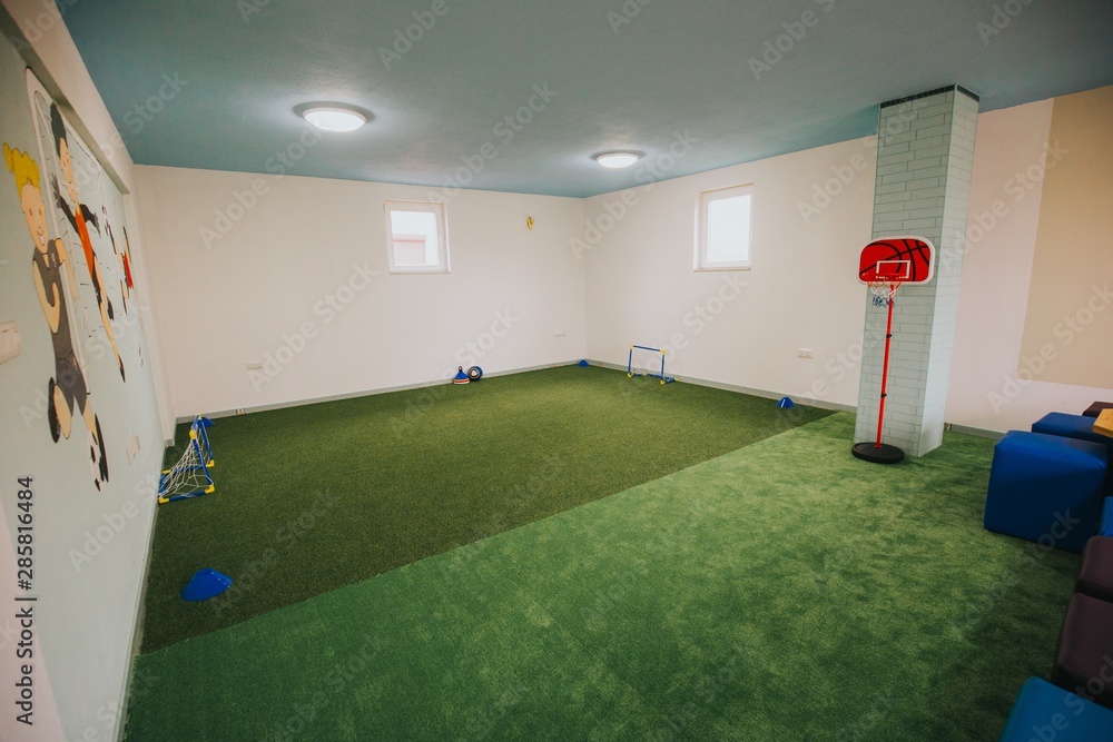 Wide shot of boys and girls playground area at a daycare center - obrazy, fototapety, plakaty 