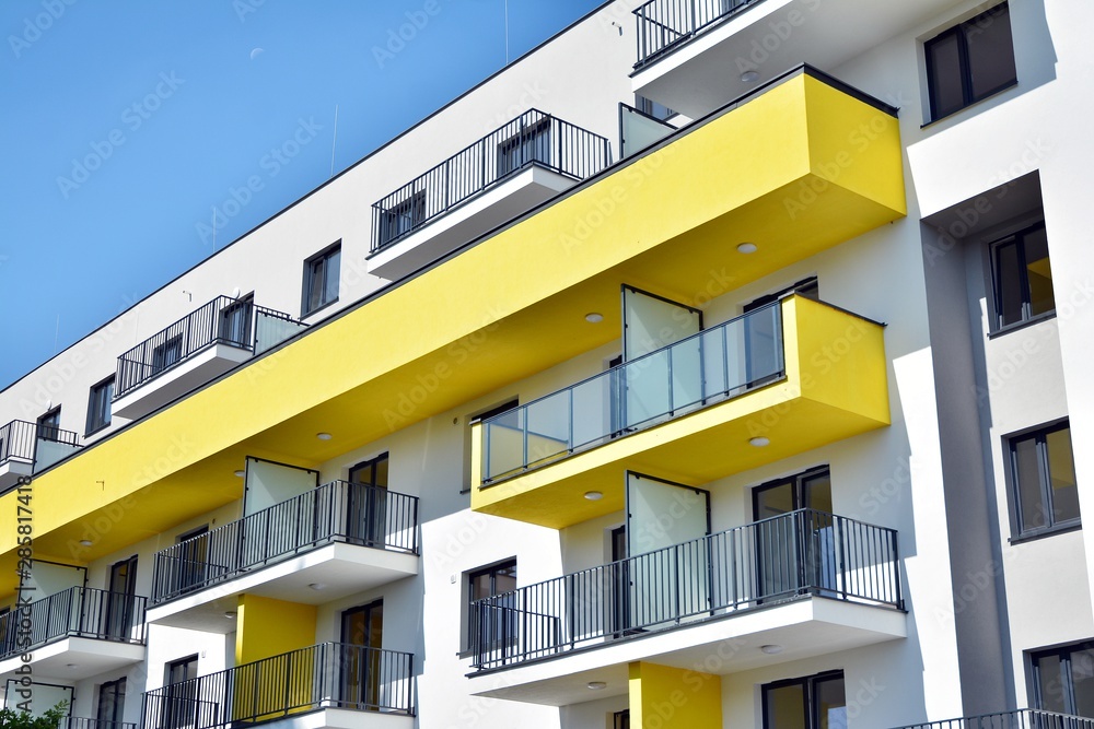 Modern apartment buildings on a sunny day with a blue sky. Facade of a modern apartment building Modern apartment buildings on a sunny day with a blue sky. Facade of a modern apartment building