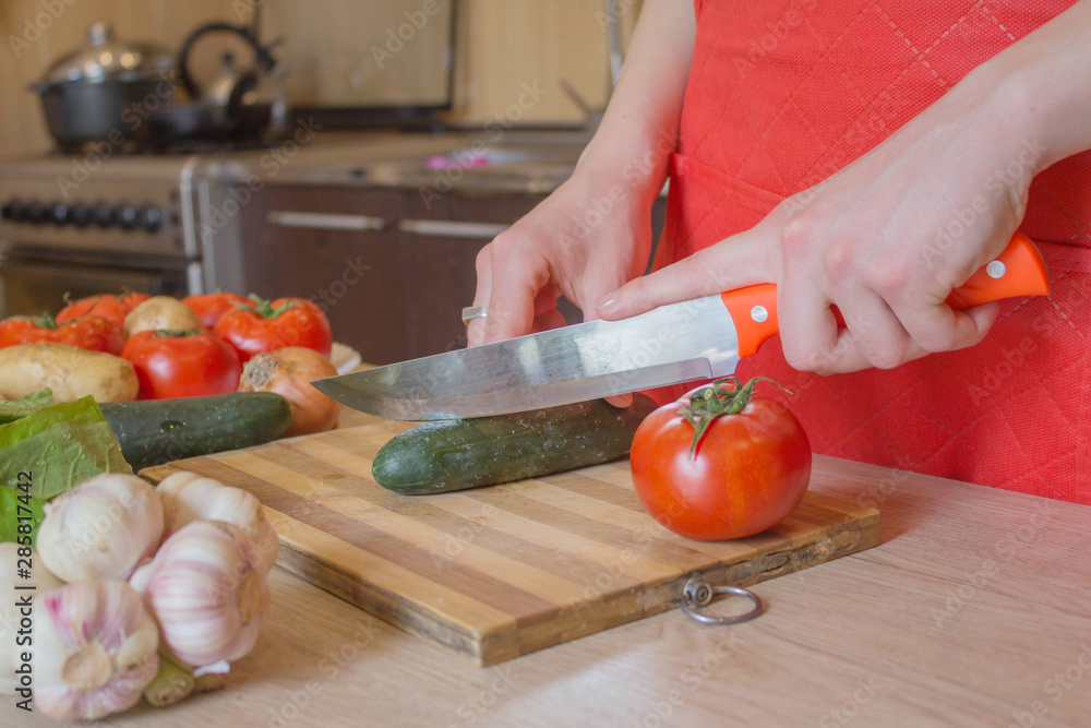 woman hands cutting vegetables on kitchen blackboard. Healthy food. Woman preparing vegetables, cooking healthy meal in the kitchen woman hands cutting vegetables on kitchen blackboard. Healthy food. Woman preparing vegetables, cooking healthy meal in the kitchen