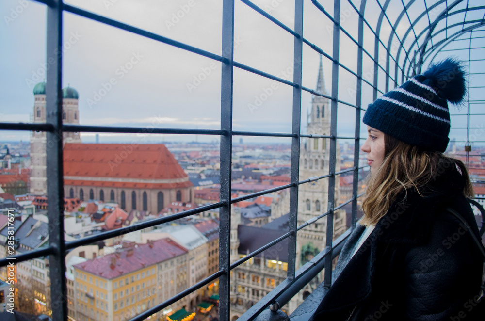Fototapeta premium Girl on the top of a church in Munich during the winter