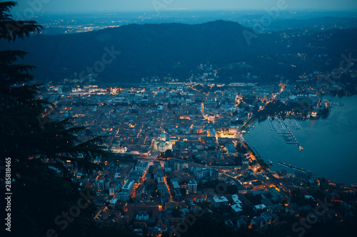 Top view of the night city of Como, Italy. Mountains, port and bay. © primipil