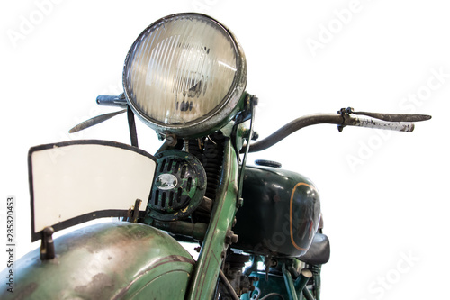 Old motorcycle, front view of light and handlebars, isolated on white background. Retro motorbike headlamp and handlebars close up.