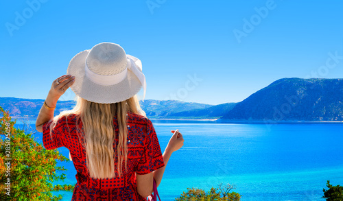 Fototapeta Naklejka Na Ścianę i Meble -  The girl with white hat looking Lake Salda from hill, Burdur, Turkey