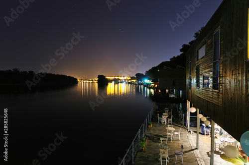Floating hostels and old town near Sava River at night in Belgrade, Serbia.