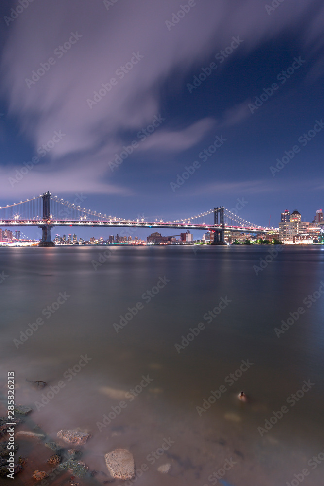Manhattan Bridge from East river beach at night with long exposure