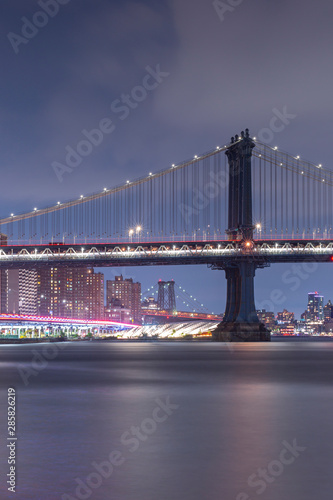 Manhattan Bridge from East river beach at night with long exposure photo