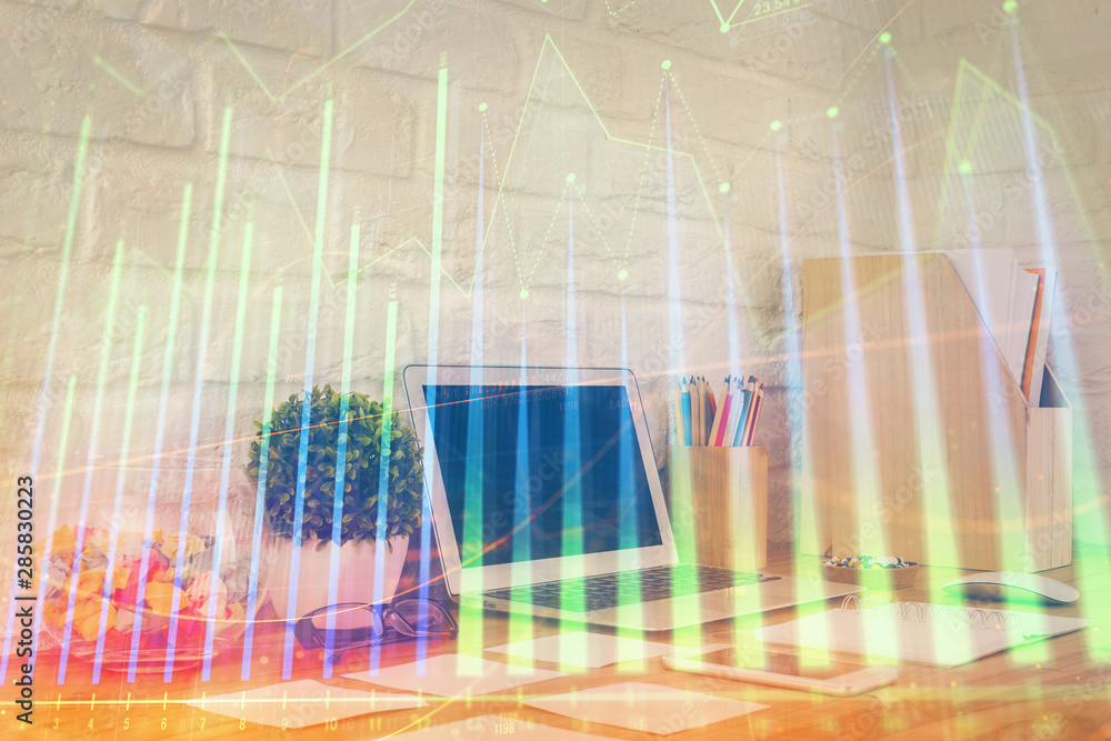 Financial market graph hologram and personal computer on background. Double exposure. Concept of forex. Financial market graph hologram and personal computer on background. Double exposure. Concept of forex.