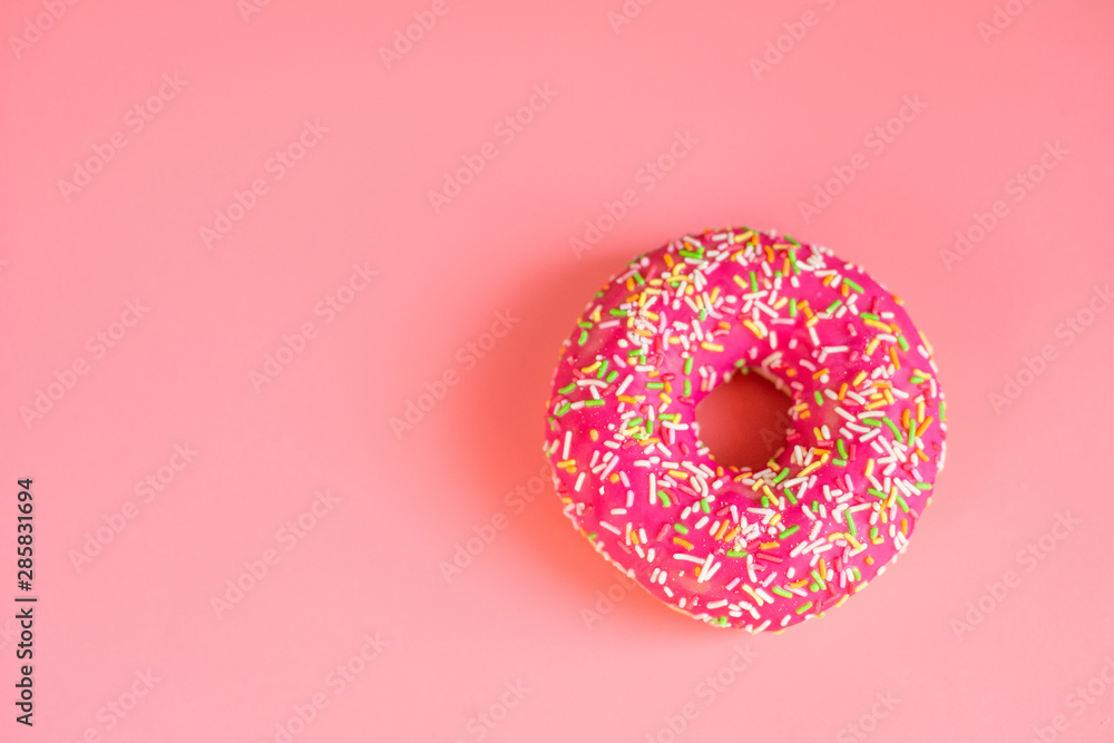 Round pink donut on pink background copy spase for text Round pink donut on pink background copy spase for text